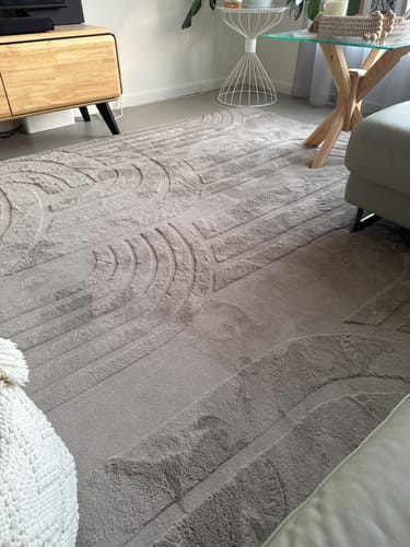Customer's Mocha Mellow Mat with a carved 3D pattern laid out in their stylish living room.