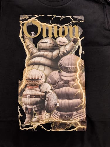Close-up of the customer's black relaxed fit T-shirt, showing the detailed graphic print of armored characters.