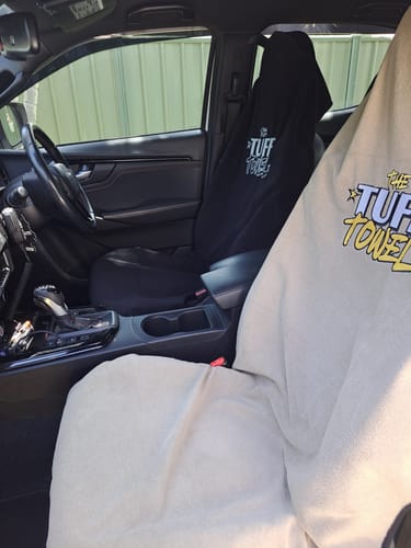 Customer's two Waterproof Car Towel Seat Covers, one black and one beige, fitted onto the front seats of a car.