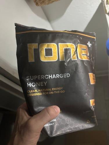 Customer holding the black pouch of SuperCharged Honey.