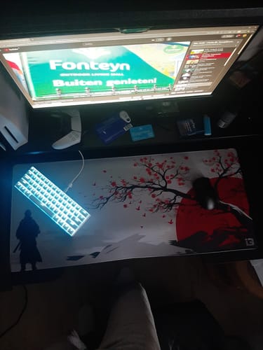 Customer's desk setup featuring the Japanese Sakura Warrior desk mat with a glowing keyboard on top.