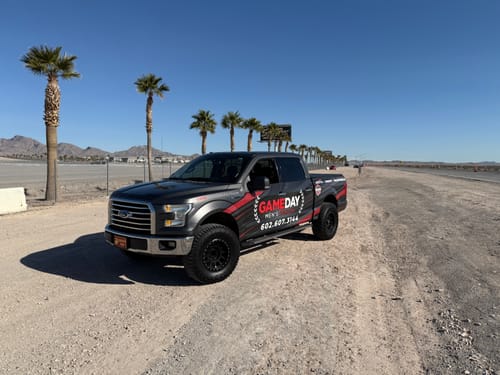 Customer's lifted gray Ford F150 parked on a dirt road after installing the aluminum forged upper control arms.