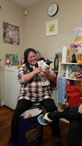 Customer happily holding the white Canada Bottle + Stickers after receiving it as a gift.