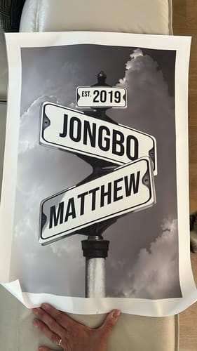 A reviewer's personalized canvas showing street signs for 'Jongbo' and 'Matthew' with the date 'EST. 2019' in black and white.