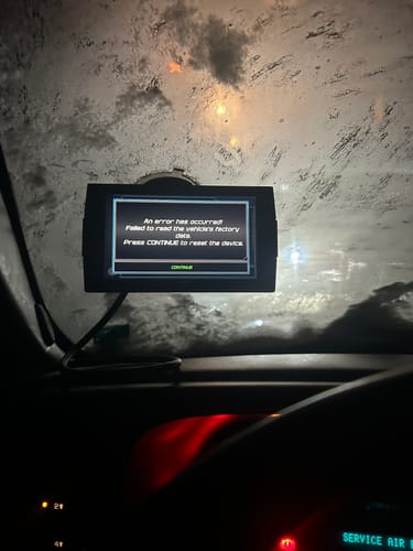 Reviewer's Evolution CTS3 tuner mounted inside a vehicle, displaying an error message about reading factory data.