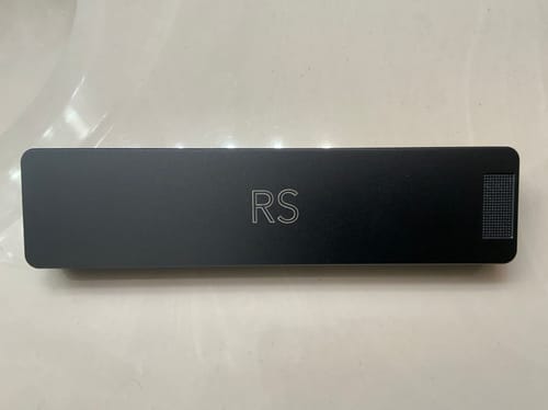 Reviewer's black Weekly Case with an 'RS' engraving, shown resting on a flat white surface.