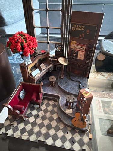 A customer's partially assembled Eternal Midnight Paris Book Nook Kit, showing a detailed miniature jazz club scene.