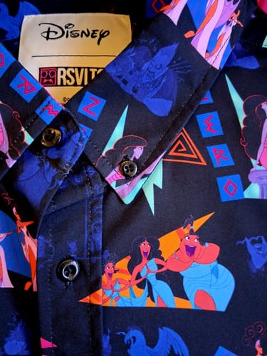 Close-up of a reviewer's black "Zero to Hero" shirt, showing the colorful pattern featuring the Muses from Disney's Hercules.