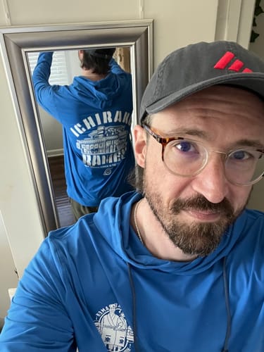 Reviewer's mirror selfie shows the front and back graphics of the blue "Ichiraku Ramen" performance hoodie.