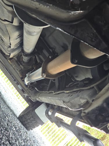 Customer's view from underneath a truck, showing the newly installed Ford Powerstroke Cat & DPF Delete Pipe.