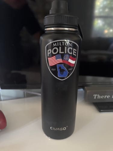 Reviewer's custom sticker with a Milton Police design applied to a black water bottle.