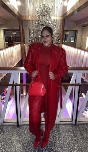 Reviewer holds open their shiny red Vegan Leather Croc Trench Coat.