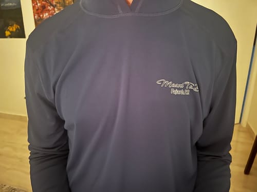 Customer shows the front of a navy long-sleeve shirt with the custom boat artwork's text logo on the chest.