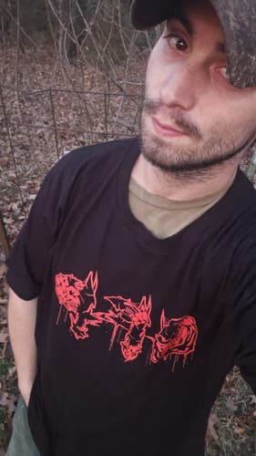 Reviewer wearing a black t-shirt with a red graphic from their Bloodline Mystery Box.