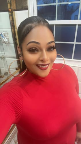 Reviewer wearing the elegant, red Naked Mock Neck Bodysuit, showing the mock neck and long sleeves.