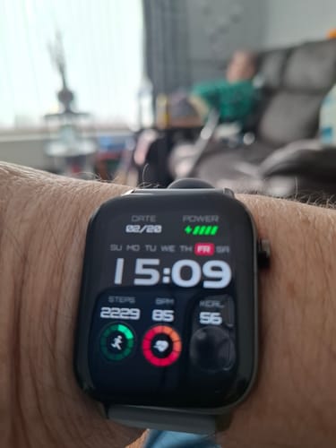 Customer's Health 2+ smartwatch on their wrist, with the digital face displaying time and health metrics.