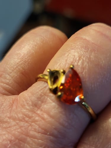 Close-up of a customer's Leesha Birthstone Ring on their hand with one stone missing from its setting.