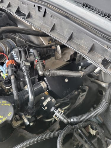 Customer's SPE Motorsport Recirculating CCV Kit installed in a 6.7L Powerstroke engine bay.