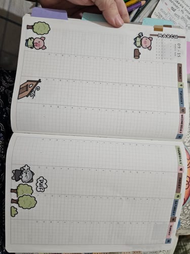 Reviewer's weekly journal spread featuring fun Three Little Pigs stickers, including the wolf and pigs, from the subscription.