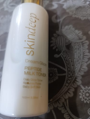 Customer's close-up of the white bottle of Dream Glaze Peptide Milk Toner.