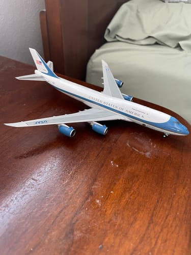 Customer's Gemini Air Force One VC25B model airplane displayed on a polished wooden surface.