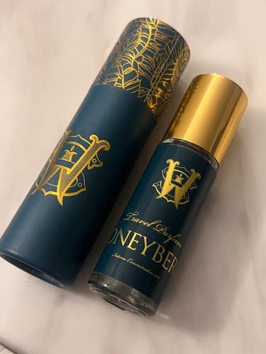 Customer's travel-size Honeyberry perfume bottle and matching case in dark teal with gold details.