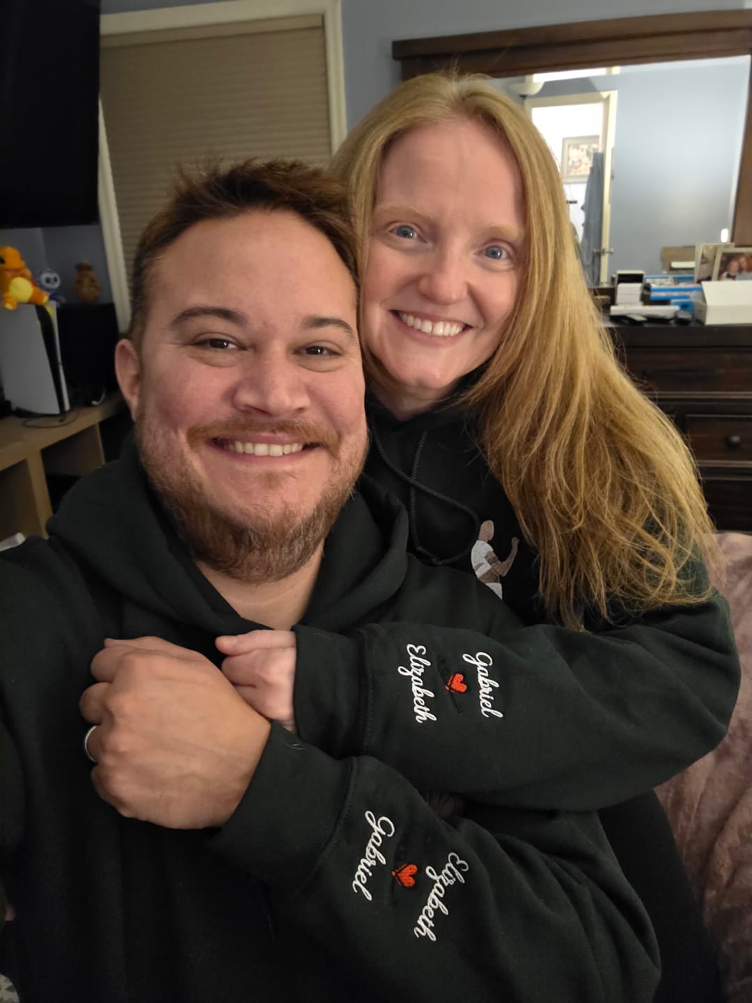 Couple wearing matching embroidered shirts