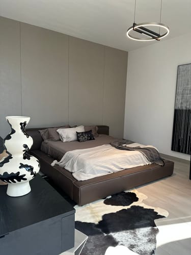 Reviewer's photo of their bedroom after the interior design service, showing a modern bed and chic decor.