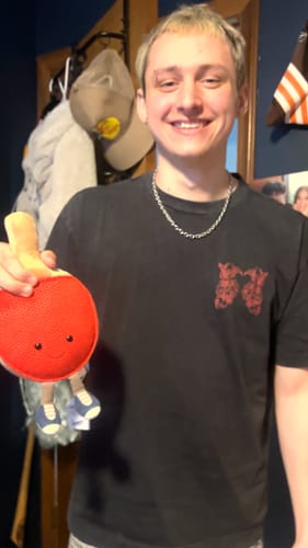 A smiling customer wearing the 6MM MINI ARIES CHAIN with a black t-shirt.