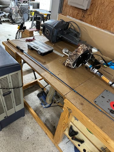 Customer's blue Waterloo Salinity rod laid out on a workbench next to a tackle box.