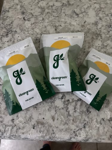 Customer's three pouches from The Core Gummies Collection—Focus, Calm, and Deep Sleep—arranged on a granite countertop.