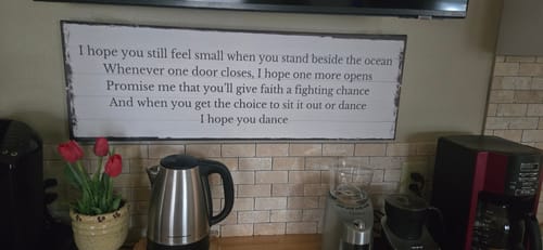 Customer's custom Canvas Quote Sign with 'I hope you dance' lyrics hanging on a wall above a kitchen counter with a coffee maker.