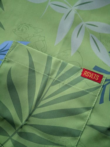 Close-up of a customer's green "The Wilde Side" shirt, showing the pocket and a hidden character within the leafy pattern.