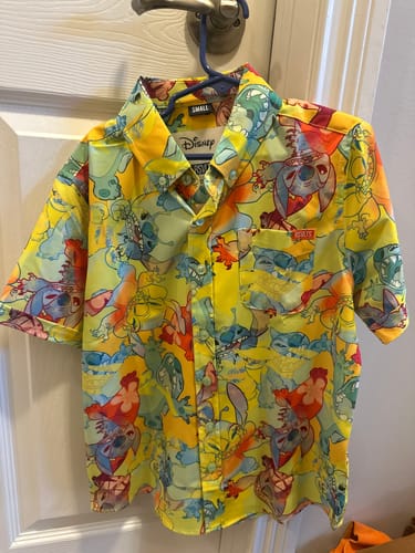 Customer's colorful Lilo & Stitch 'Tropical Troublemaker' shirt on a hanger.