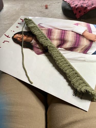 Reviewer starting a knitting project with the textured green yarn from the Knitter of the Month kit.