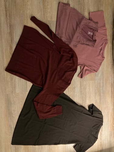 Customer displays their Mystery Item purchase: a long-sleeve shirt, a top with leggings, and a t-shirt dress, all laid out on a floor.