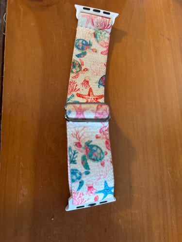Customer's Trust The Journey Watch band lying flat, showing a colorful pattern of sea turtles and starfish.