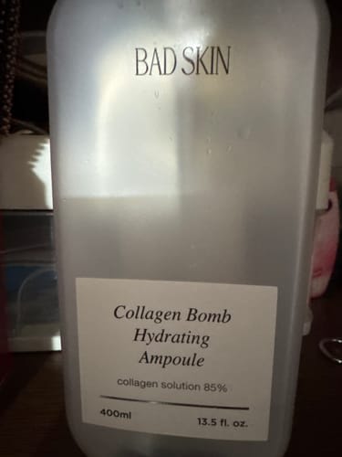 Customer's large, translucent 400ml bottle of Bad Skin Collagen Bomb Hydrating Ampoule.