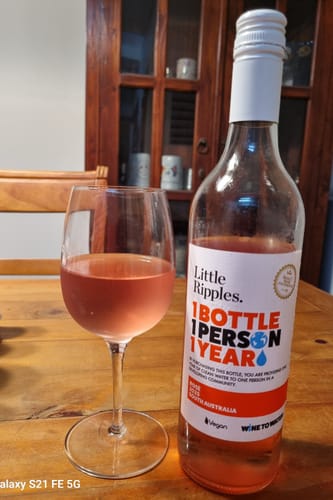 Reviewer's bottle of Rosé from the Fan Favourites pack, shown next to a poured glass on a wooden table.