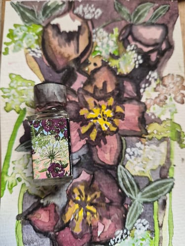 Customer's Hellebore And Hemlock perfume bottle placed in front of a moody, artistic watercolor painting of flowers.