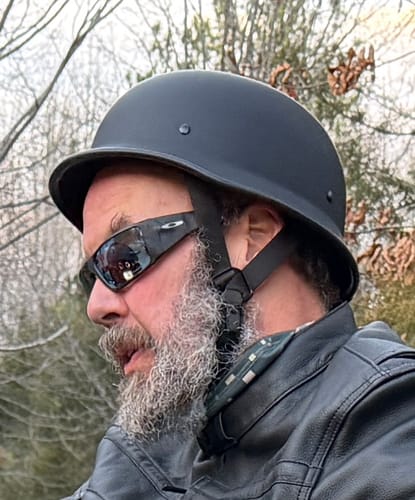 Close-up side view of a reviewer wearing the Mayan DOT Germanator Beanie Black helmet.