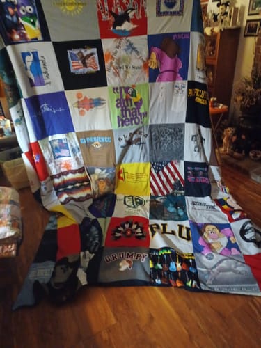 Customer's large remembrance Premium T Shirt Quilt made from dozens of personal shirts, displayed in their home.