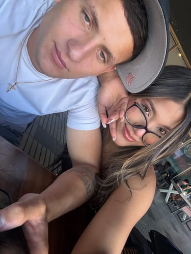 Cliente en una selfi con un hombre que lleva puesto el colgante Cross Minimal Oro.