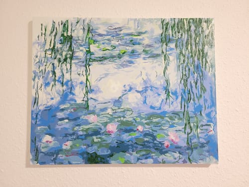 Reviewer's finished Water Lilies paint by numbers canvas, showing blended shades of bright blue water and green leaves.