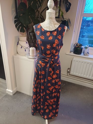Customer's sleeveless wrap dress made from Red Floral on Navy Viscose Challis Fabric, shown on a mannequin.