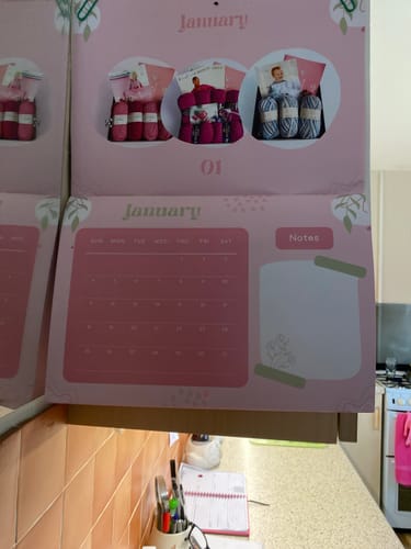 Customer's pink KIAB 2026 Calendar open to January, showing the monthly grid and a space for notes.