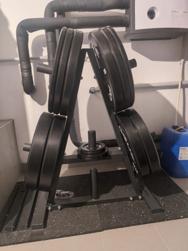 Customer's black Triangle Weight Tree shown loaded with heavy weight plates in a home gym.