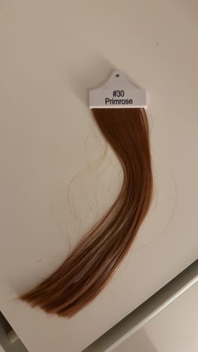 Customer's Primrose #30 colour sample, a warm light auburn shade, lying flat on a white surface.