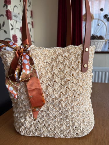 Customer's finished cream Aveline crochet Shoulder Bag, with a patterned scarf tied to the leather strap.