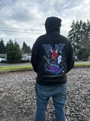 Customer from behind wearing the black DARK GEISHA HOODIE, showing the detailed graphic on the back.